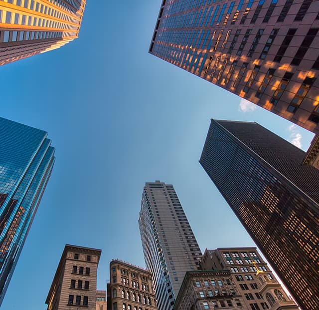 An upward view of skyscrapers from the street