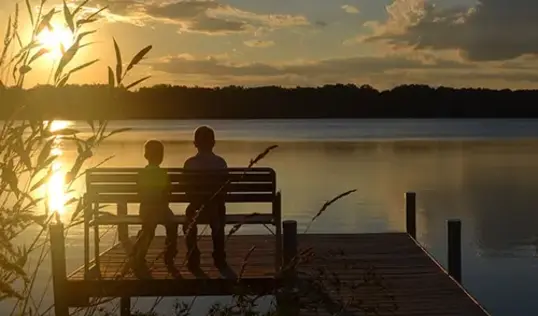 Two kids enjoying the views of the lake.