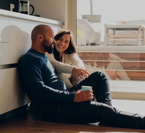 Couple sitting on kitchen floor talking